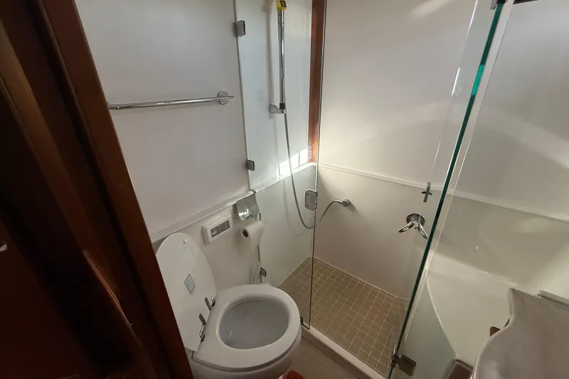 Slide: The Image of Bathroom interior of 2017 Sabre 48 Salon Express yacht, featuring shower and toilet. - 46