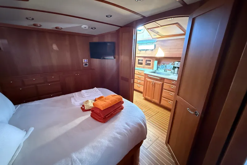 Slide: The Image of Luxurious 2017 Sabre 48 Salon Express cabin with cozy bed and elegant wood interior. - 47