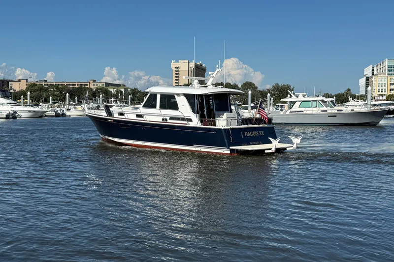 Slide: The Image of 2017 Sabre 48 Salon Express yacht on calm water, cityscape background. - 5