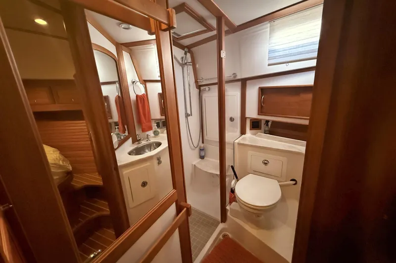 Slide: The Image of Bathroom interior of 2017 Sabre 48 Salon Express yacht, featuring wood accents and modern fixtures. - 51