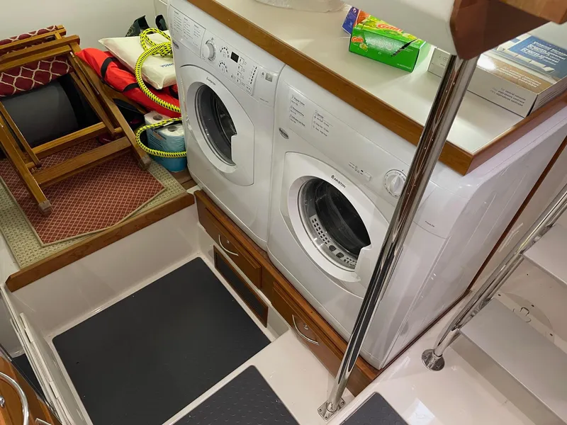Slide: The Image of Laundry area on 2017 Sabre 48 Salon Express yacht with washer and dryer. - 54