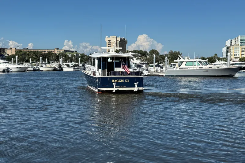 Slide: The Image of 2017 Sabre 48 Salon Express yacht in a marina, clear sky, calm water. - 8