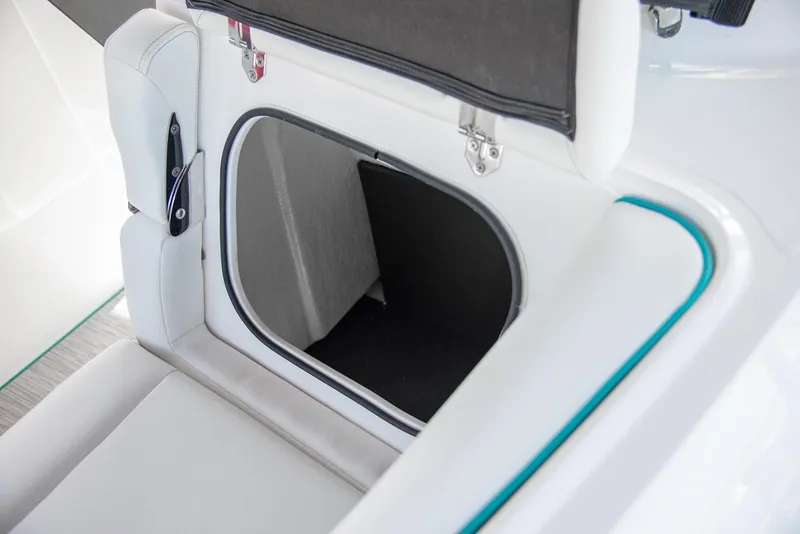 Slide: The Image of Manufacturer Provided Image: 2026 Regal LS4 boat storage compartment with white cushioned seating. - 12