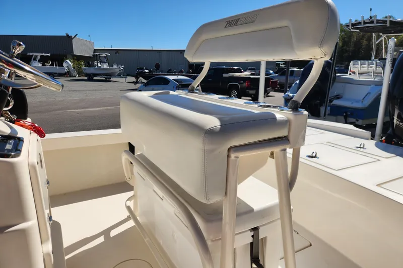 Slide: The Image of 2015 Pathfinder 2300 HPS boat interior with white seating and steering wheel. - 13