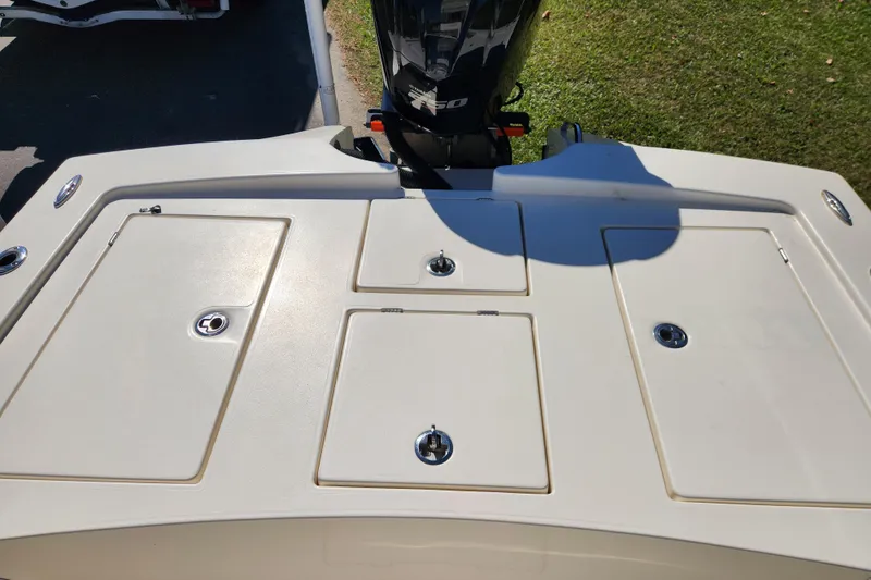 Slide: The Image of 2015 Pathfinder 2300 HPS boat deck with storage compartments and outboard motor. - 14