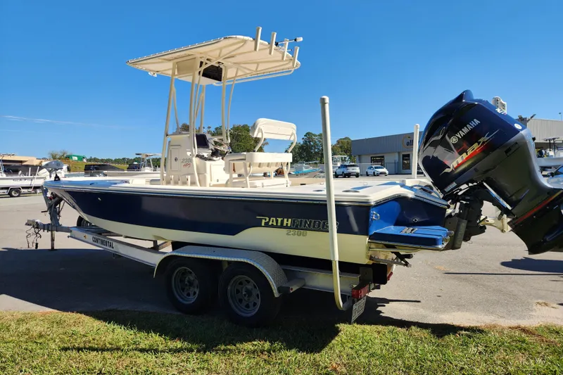 Slide: The Image of 2015 Pathfinder 2300 HPS boat on trailer with Yamaha engine, parked outdoors. - 5