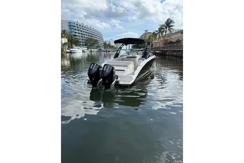 Slide: The Image of 2021 Sea Ray SDX 290 Outboard boat on calm water near waterfront buildings. - 18