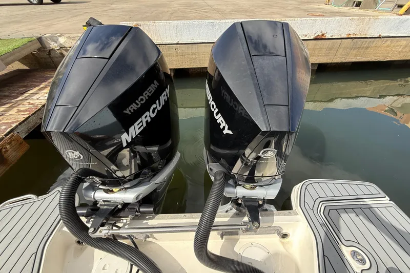 Slide: The Image of Twin Mercury outboard engines on a 2021 Sea Ray SDX 290 boat at the dock. - 20