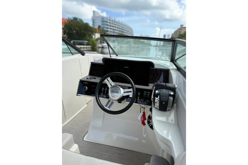 Slide: The Image of 2021 Sea Ray SDX 290 Outboard helm with steering wheel and controls. - 22