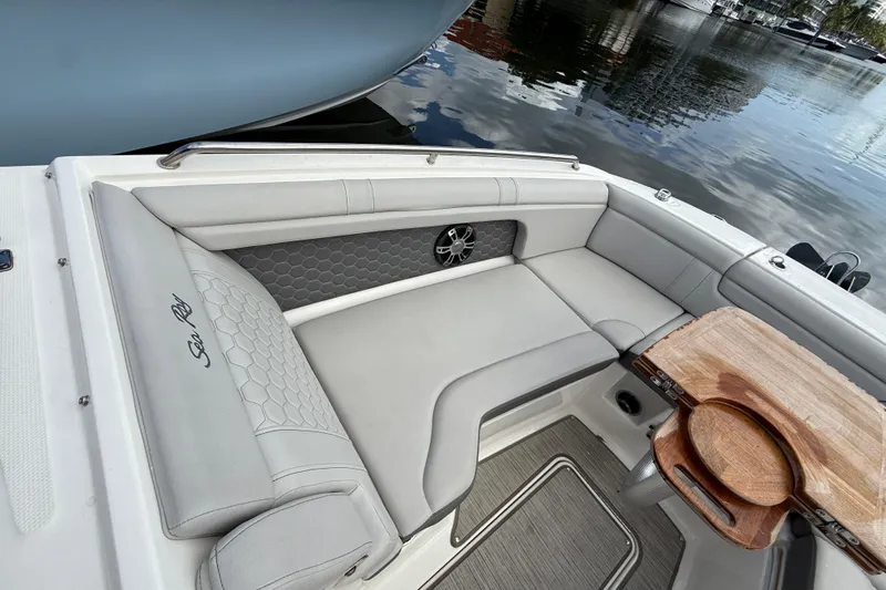 Slide: The Image of 2021 Sea Ray SDX 290 Outboard boat interior with elegant seating and wooden table. - 27
