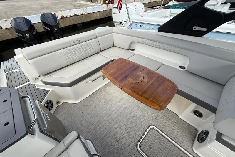 Slide: The Image of 2021 Sea Ray SDX 290 Outboard interior with elegant seating and wooden table. - 39