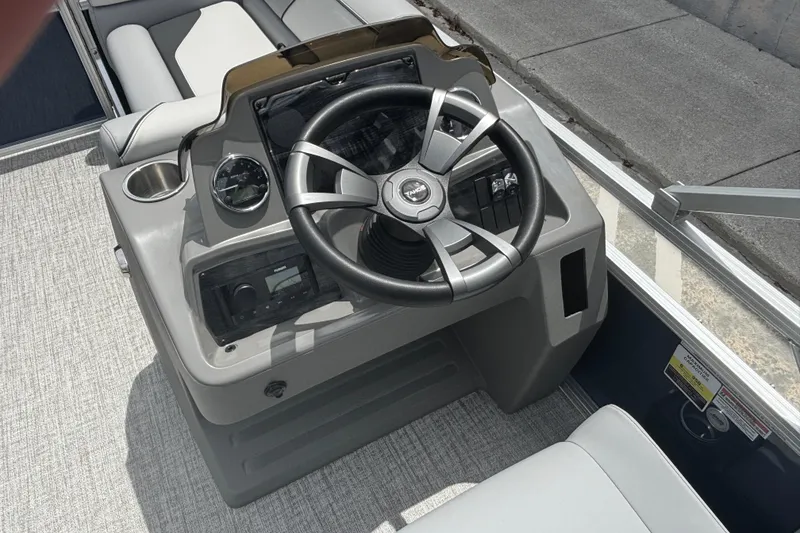 Slide: The Image of Steering console of 2026 Tahoe Pontoon 1780 with modern controls and seating. - 6