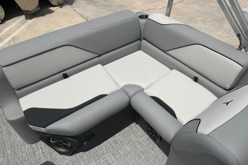 Slide: The Image of 2026 Tahoe Pontoon 1780 interior seating with gray and white upholstery, featuring cup holders. - 7