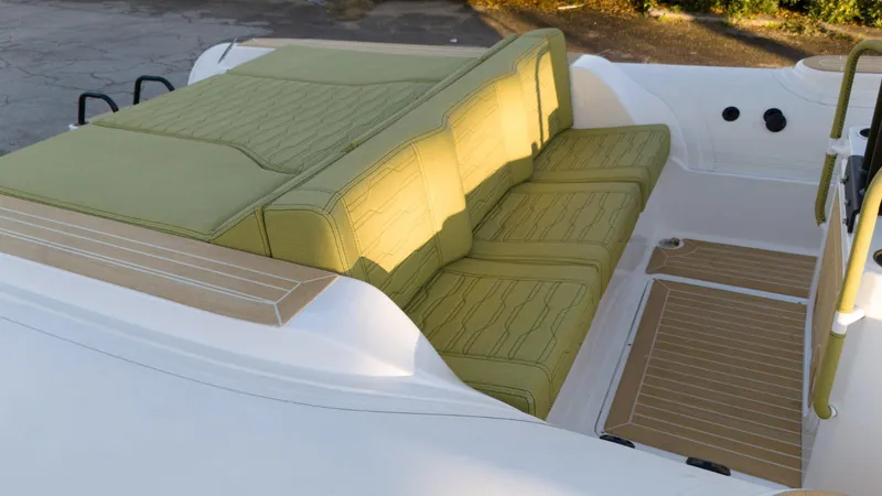 Slide: The Image of 2025 Aqvaboats Luxrib 25 interior with green seating and sleek design. - 10