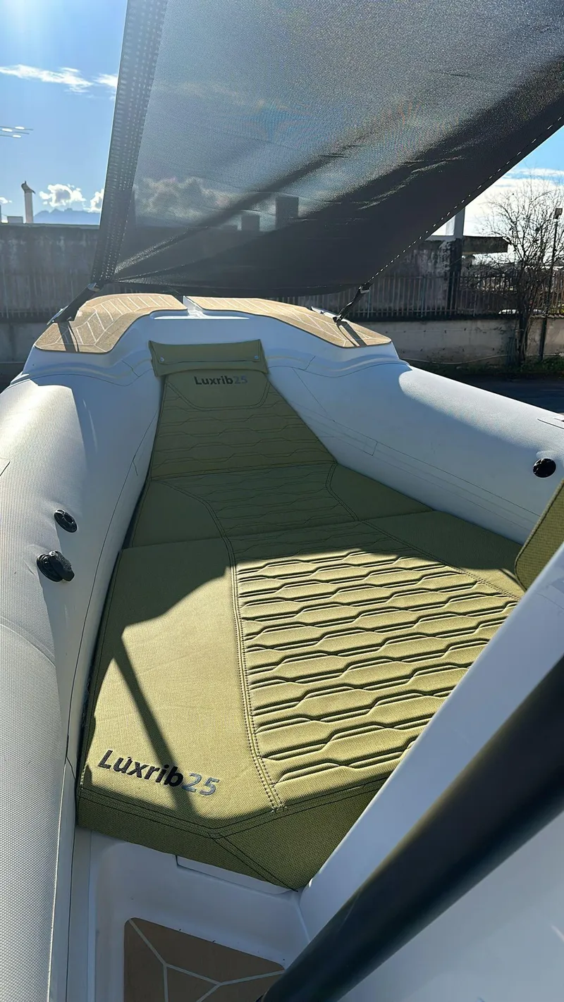 Slide: The Image of Aqvaboats Luxrib 25, 2026 model, featuring a sleek deck with comfortable seating. - 17