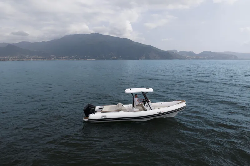 Slide: The Image of Aqvaboats Luxrib 25 (2026) cruising on calm waters with mountainous backdrop. - 21