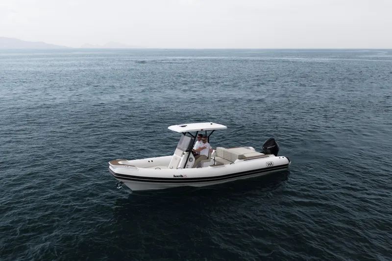 Slide: The Image of Aqvaboats Luxrib 25 (2026) cruising on open water, showcasing sleek design and modern features. - 25