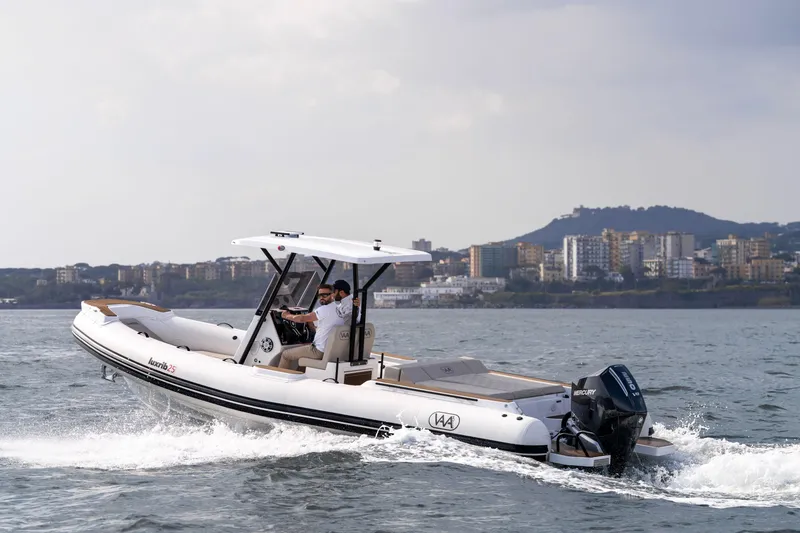 Slide: The Image of 2026 Aqvaboats Luxrib 25 cruising on water with cityscape in background. - 33