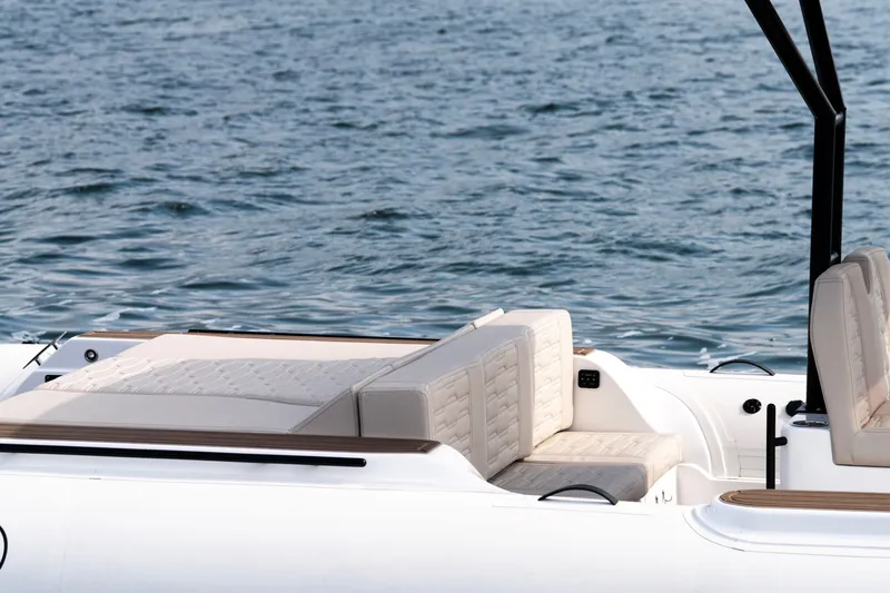 Slide: The Image of 2026 Aqvaboats Luxrib 25 with beige seating, on calm water. - 40