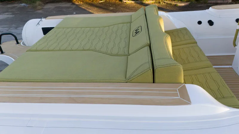 Slide: The Image of Aqvaboats Luxrib 25, 2025 model, featuring green cushioned seating on deck. - 9