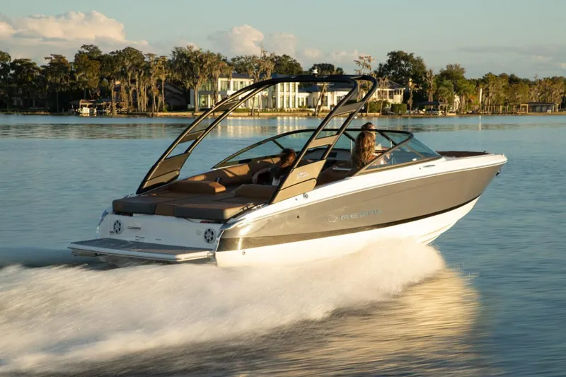 Slide: The Image of Manufacturer Provided Image: 2026 Regal LS2 boat cruising on a serene lake at sunset. - 2