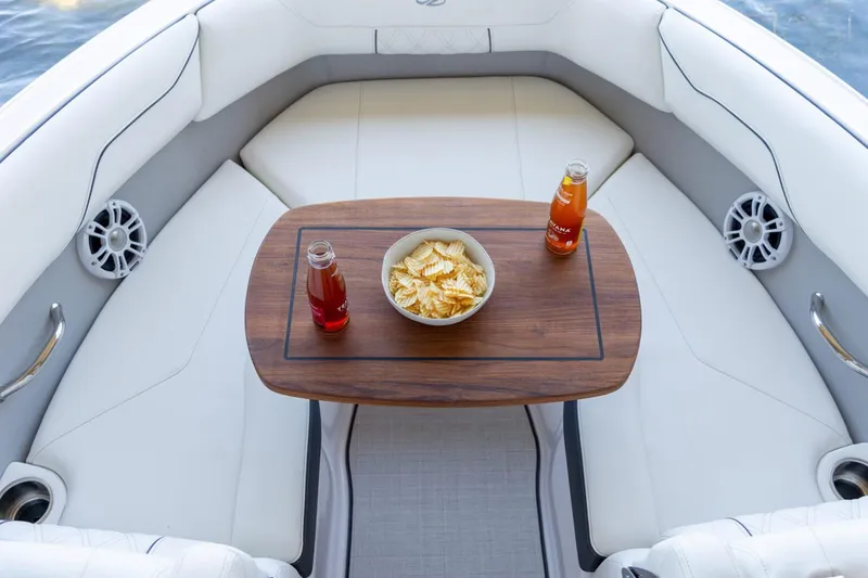 Slide: The Image of Manufacturer Provided Image: 2026 Regal LS2 boat interior with table, snacks, and drinks on white seating. - 5