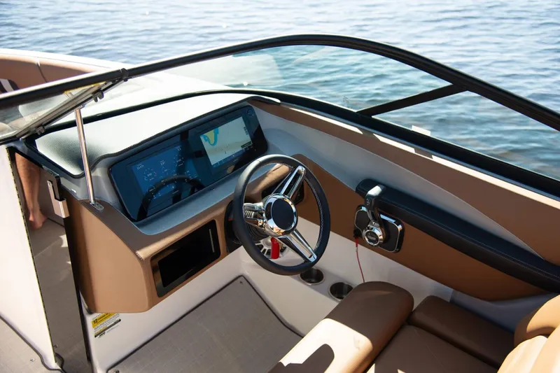 Slide: The Image of Manufacturer Provided Image: 2026 Regal LS2 boat dashboard with steering wheel and control panel on water. - 7