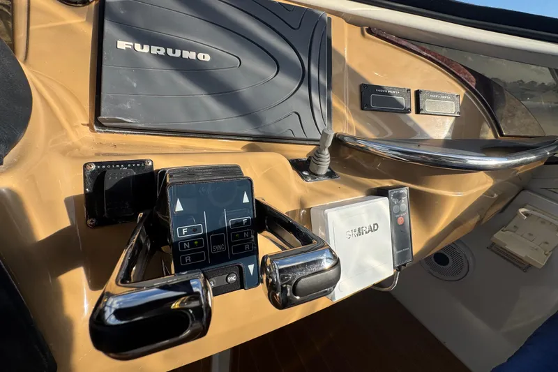 Slide: The Image of Control panel of a 2003 Carver 444 Cockpit Motor Yacht with navigation equipment. - 15