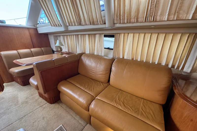 Slide: The Image of 2003 Carver 444 Cockpit Motor Yacht interior with leather seating and dining area. - 20