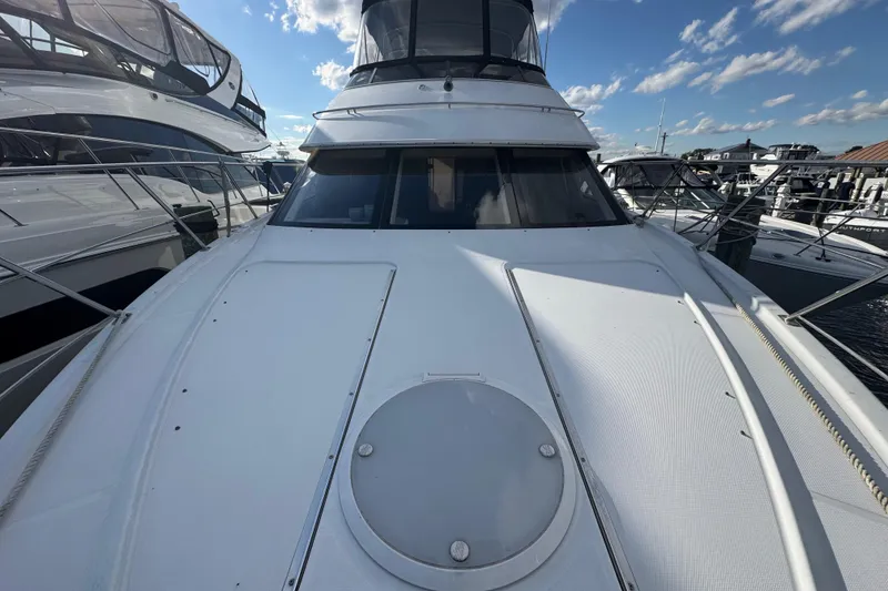 Slide: The Image of 2003 Carver 444 Cockpit Motor Yacht docked under a clear blue sky. - 4