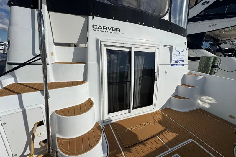 Slide: The Image of 2003 Carver 444 Cockpit Motor Yacht with teak steps and sliding glass door. - 5