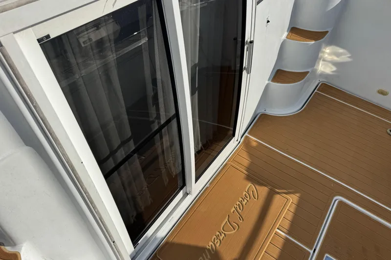 Slide: The Image of 2003 Carver 444 Cockpit Motor Yacht with teak deck and sliding glass doors. - 8
