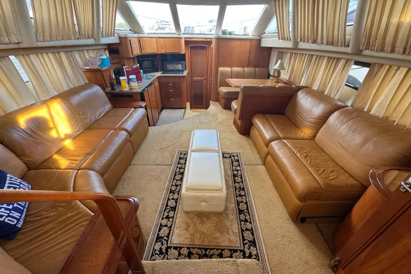 Slide: The Image of Luxurious interior of 2003 Carver 444 Cockpit Motor Yacht with leather seating and kitchenette. - 17