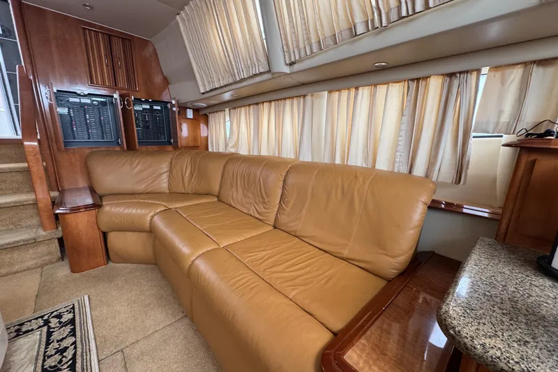 Slide: The Image of Interior of 2003 Carver 444 Cockpit Motor Yacht with leather seating and wood accents. - 28