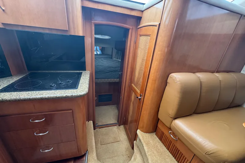 Slide: The Image of Interior of 2003 Carver 444 Cockpit Motor Yacht with kitchen and seating area. - 31