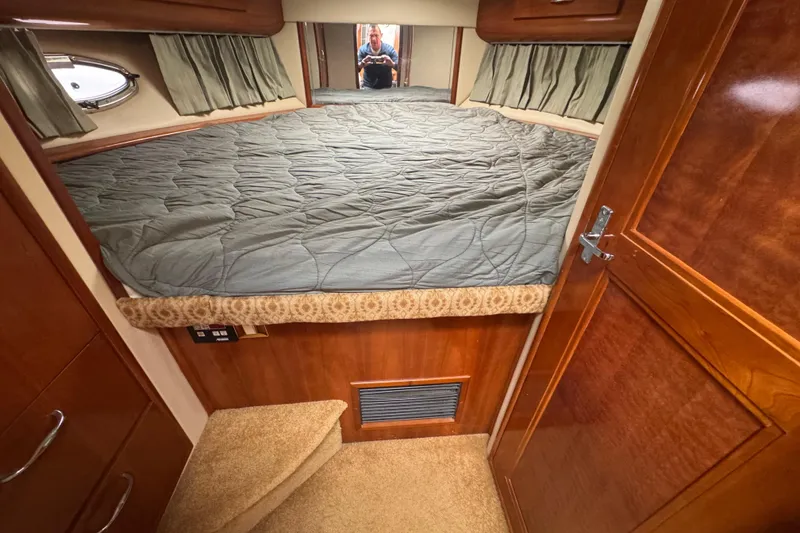 Slide: The Image of Cozy cabin interior of 2003 Carver 444 Cockpit Motor Yacht with bed and wood finish. - 32