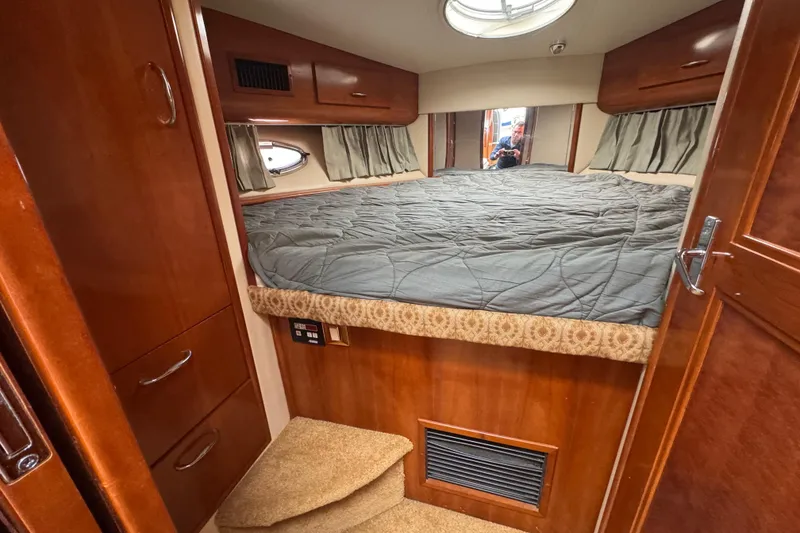 Slide: The Image of Interior cabin of 2003 Carver 444 Cockpit Motor Yacht with bed and wood cabinetry. - 33