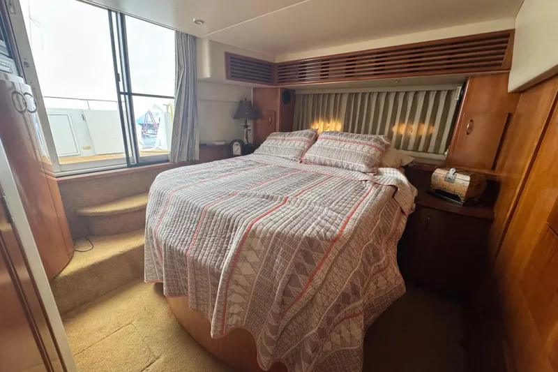 Slide: The Image of Interior of 2003 Carver 444 Cockpit Motor Yacht with cozy bedroom setup. - 36