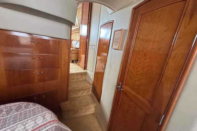 Slide: The Image of Interior of 2003 Carver 444 Cockpit Motor Yacht with wooden cabinetry and carpeted stairs. - 37