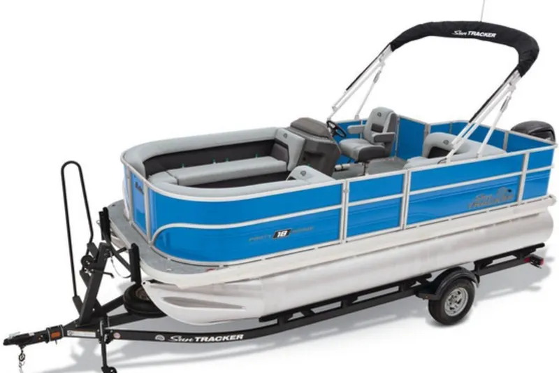 The Image of 2026 Sun Tracker Party Barge 18 DLX pontoon boat on trailer, blue and white design. - 1