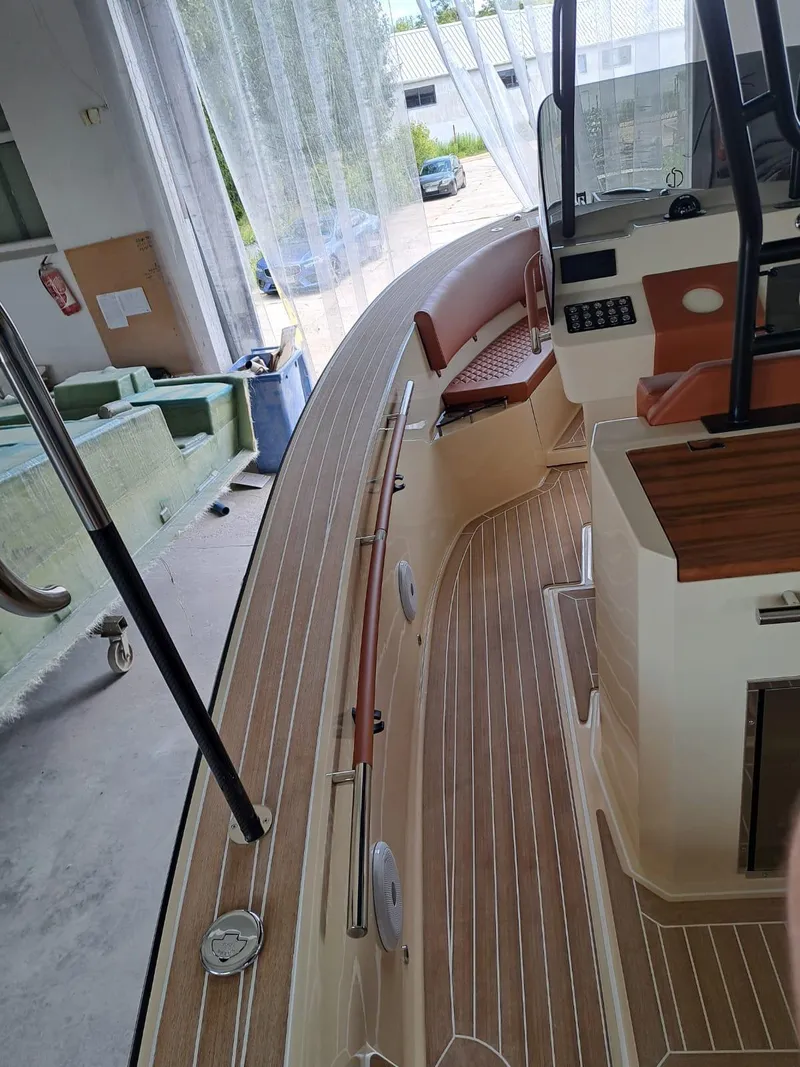 Slide: The Image of 2025 Lilybaeum Levanzo 25 Lounge Deck boat interior with wood finish and seating. - 12