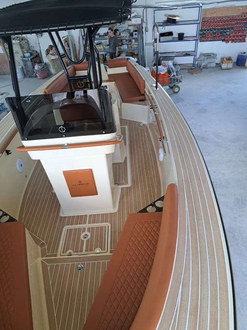 Slide: The Image of 2025 Lilybaeum Levanzo 25 Lounge Deck boat with elegant wood finish and cushioned seating. - 16
