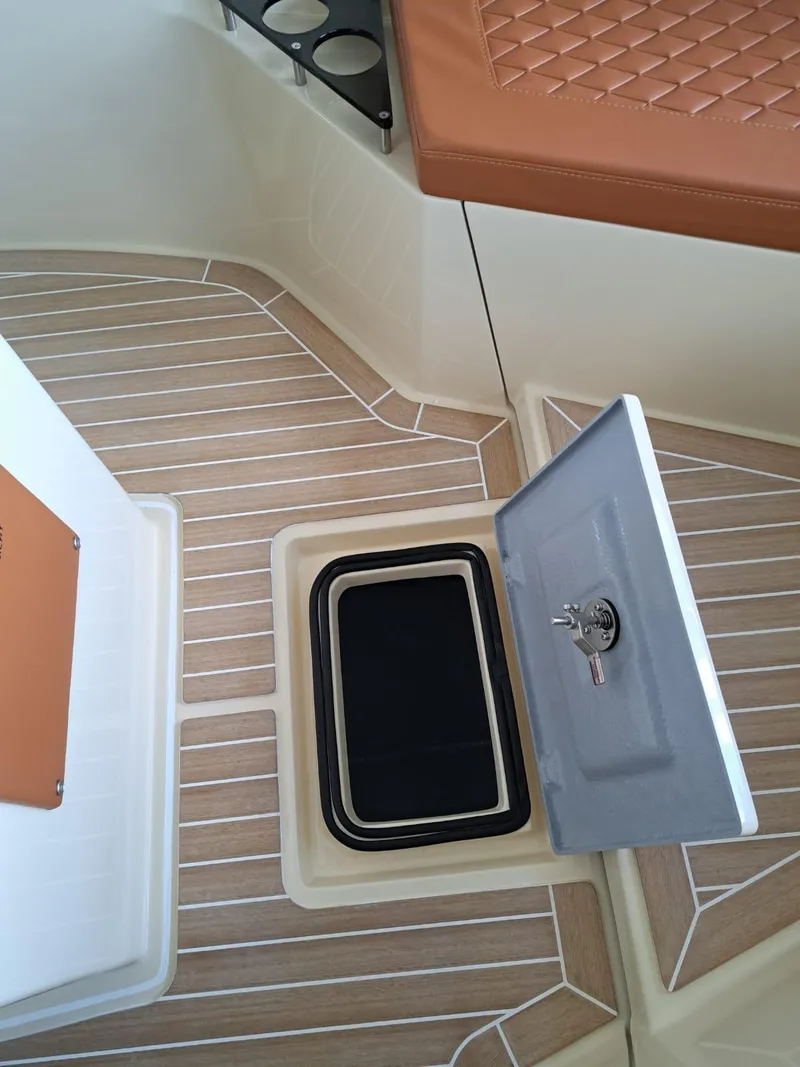 Slide: The Image of 2025 Lilybaeum Levanzo 25 Lounge Deck with open storage compartment and cushioned seating. - 17