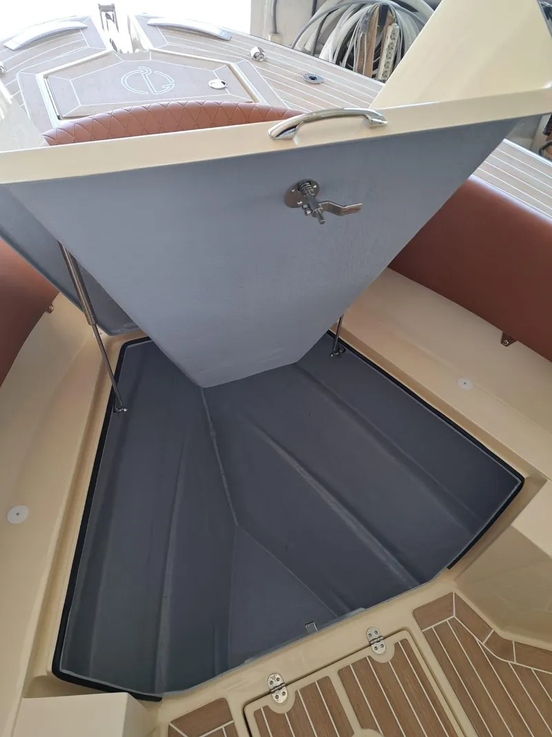 Slide: The Image of 2025 Lilybaeum Levanzo 25 Lounge Deck interior storage compartment with open hatch and key lock. - 18