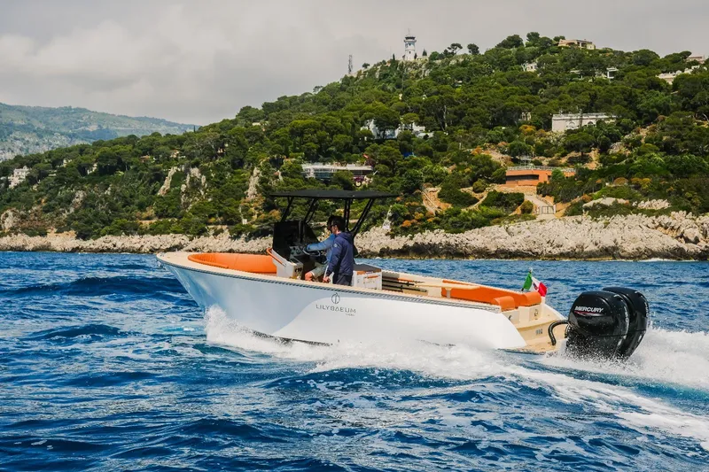 Slide: The Image of 2025 Lilybaeum Levanzo 25 Lounge Deck boat cruising near scenic coastline. - 3