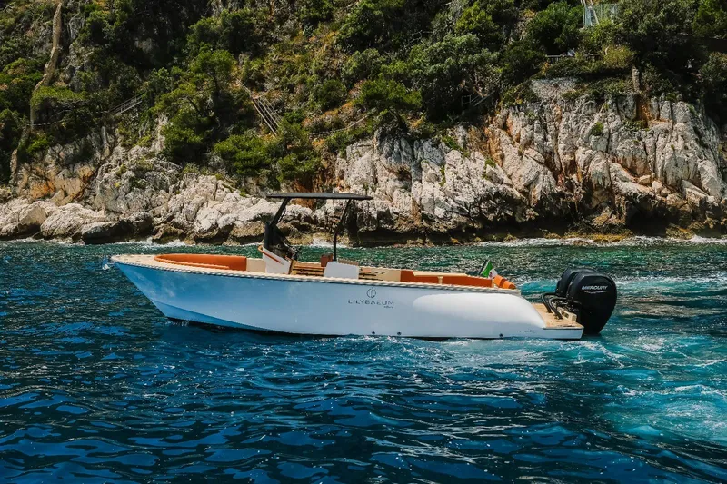 Slide: The Image of 2025 Lilybaeum Levanzo 25 Lounge Deck boat cruising near rocky coastline. - 4