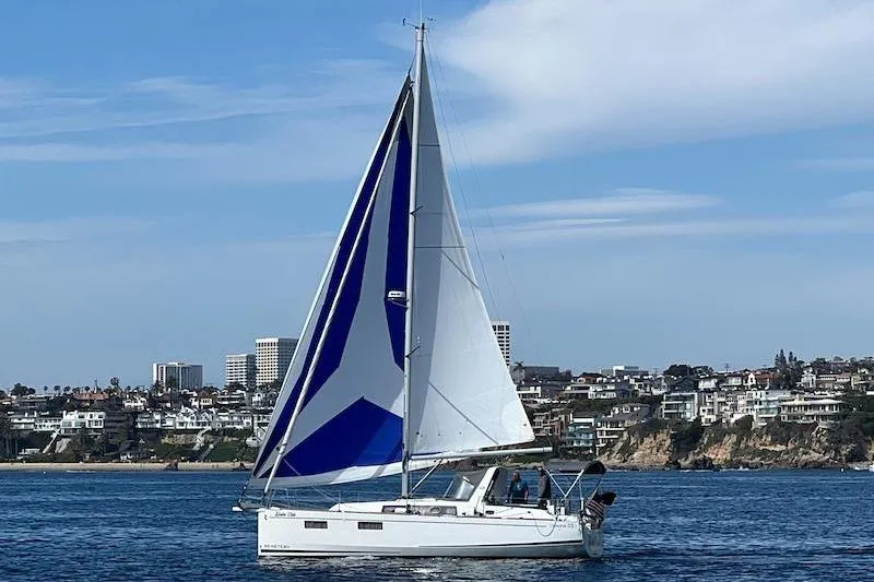 Slide: The Image of Sailboat Beneteau Oceanis 35.1 (2022) cruising near coastal cityscape. - 10