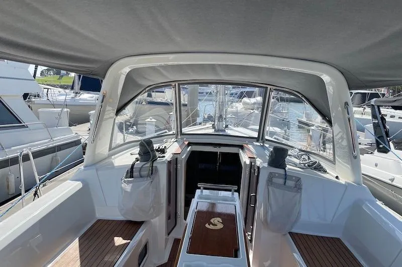 Slide: The Image of 2022 Beneteau Oceanis 35.1 yacht cockpit with canopy, docked at marina. - 2