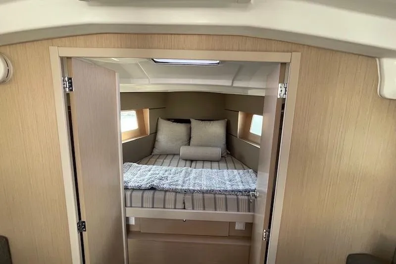 Slide: The Image of Interior cabin of 2022 Beneteau Oceanis 35.1 yacht, featuring cozy bed and modern design. - 6
