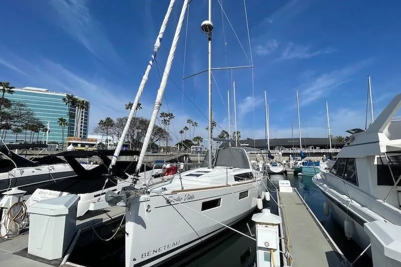 Slide: The Image of 2022 Beneteau Oceanis 35.1 sailboat docked at marina under clear blue sky. - 9